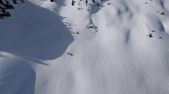 Aerial View of Majestic Snow-Covered Mountains and Ski Tracks in British Columbia, Canada