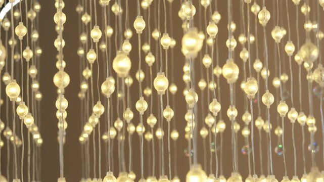 Golden Beaded Chandelier Hanging from Ceiling with Sparkling Crystal Ornaments in Luxury Interior