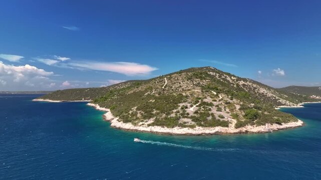 Aerial view of Vini&scaron;će bay peninsula tip on sunny clear day with passing motorboat (part 2)