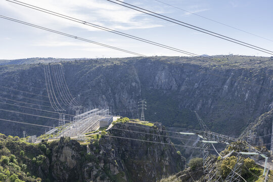 View of Aldeadavila II Electrical Substation on a rocky cliff overlooking a deep canyon with high-voltage power lines and pylons Aldeadavila de la Ribera, Castile and Leon, Spain.