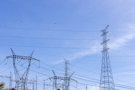View of the Aldeadavila II Electrical Substation with high-voltage transmission towers and power lines under a clear blue sky Aldeadavila de la Ribera, Castile and Leon, Spain.