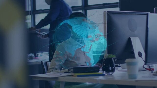 Woman office worker working at monitor holo globe appearing and covering torso as coworker passing