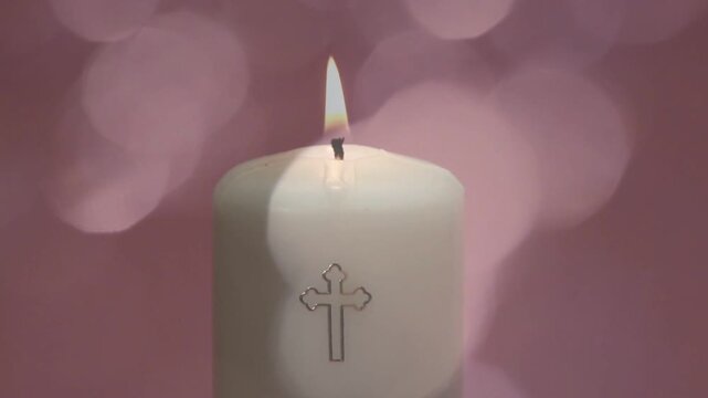 White candle flame flickering and extinguishing after moving light crosses face, leaving smoke