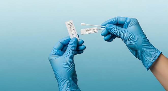 Two hands wearing blue disposable gloves compare two rapid antigen test strips with visible control and test lines.