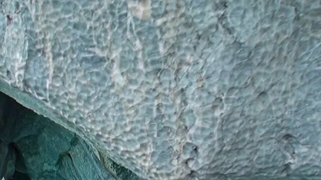 Immerse in Patagonia's Marble Caves, a wondrous gallery of water-carved marble. Azure hues dance upon sculpted rock and tranquil waters, showcasing an ancient, captivating beauty.