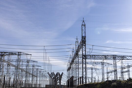 View of Aldeadavila II Electrical Substation with high-voltage power lines and steel pylons under a clear blue sky Aldeadavila de la Ribera, Castile and Leon, Spain.