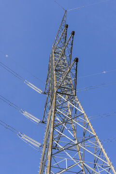 View of Aldeadavila II Electrical Substation with its steel lattice transmission tower and power lines against a clear blue sky in Aldeadavila de la Ribera, Castile and Leon, Spain.