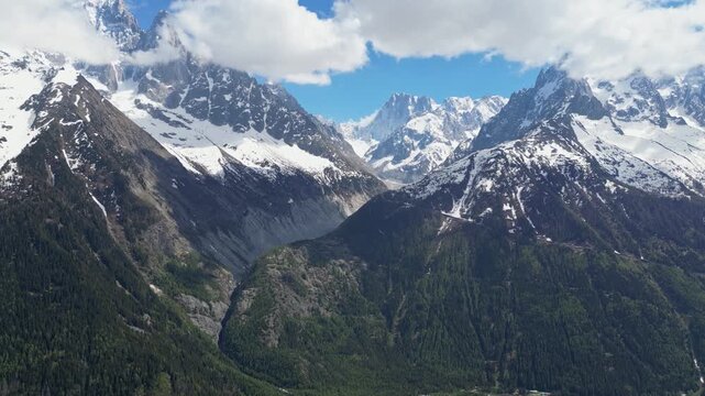 Wide cinematic drone panorama of the Mer de Glace glacier surrounded by dramatic snowy peaks and alpine landscapes in the Chamonix valley, France, captured from above in the heart of the French Alps.
