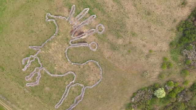 Aerial top down view of a large horse figure geoglyph on Siva Brada hill. Stone artwork created during the Celtic era near Spis Castle