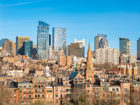 Boston skyline rising above historic brownstone neighborhoods