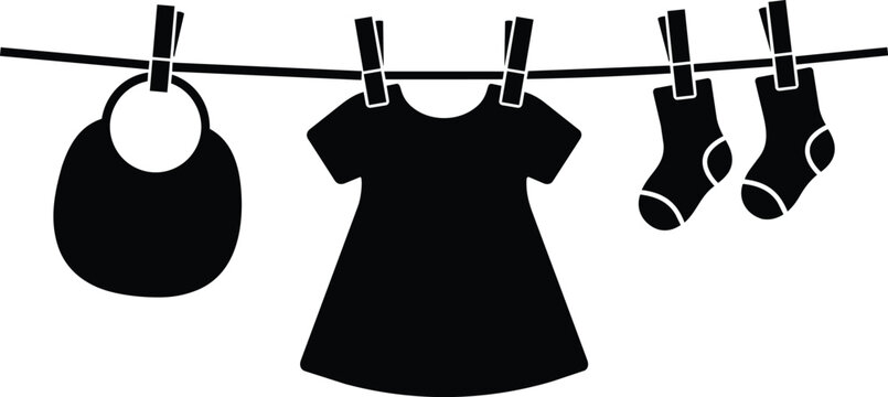 Flat black and white baby dress bib and socks hanging on clothesline with clothespins