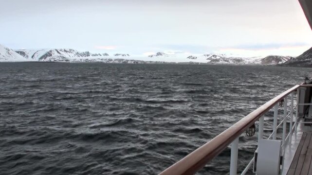 Experience a tranquil moment aboard a ship traversing the mighty Arctic Ocean in Norway.