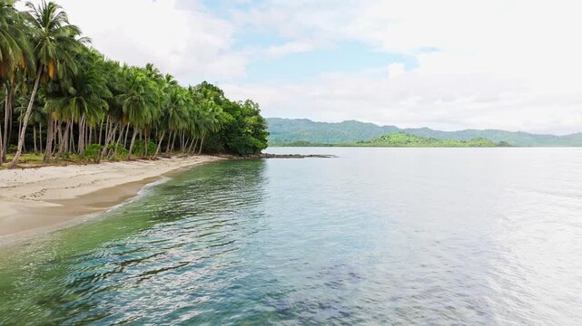 Drone flies along Coconut Beach Palawan where waves reshape shoreline boundary