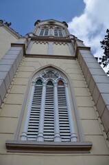 Obraz premium Neo Gothic Church Facade Detail with Arched Window and Blue Sky