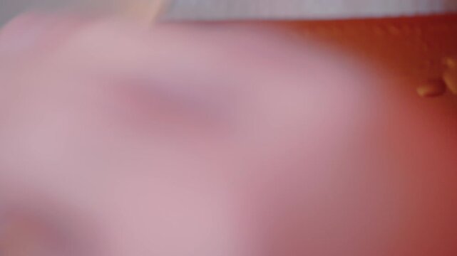Macro close up of person sharpening chefs knife using a whetstone