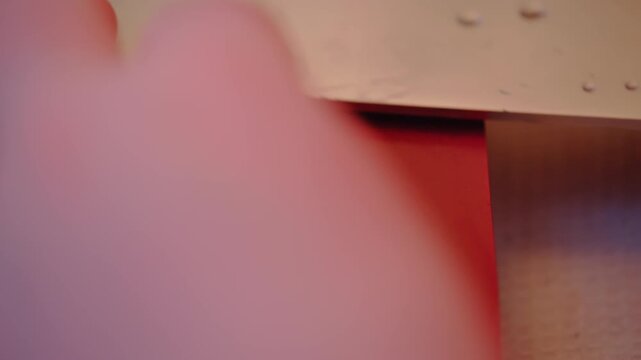 Macro close up of person sharpening chefs knife using a whetstone