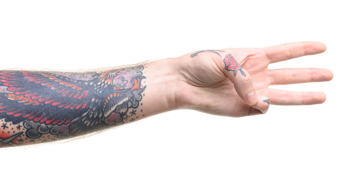 Man with tattoos showing three fingers on white background, closeup