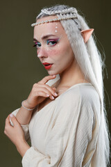 Naklejka premium Beautiful elf girl on dark olive background