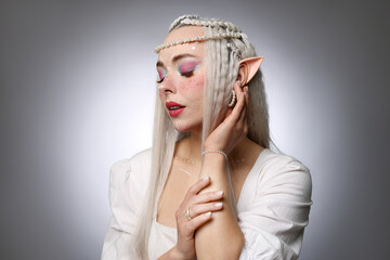 Naklejka premium Beautiful elf girl on grey gradient background