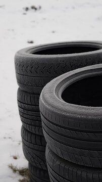 Stack of used summer tires near roadside