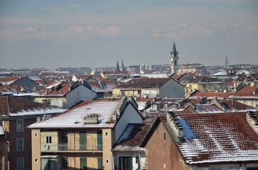 Obraz premium Snow Covered Rooftops in Turin Italy with Alps Mountain Range