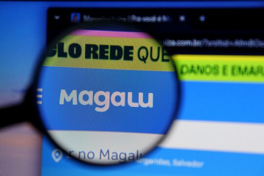 Salvador, Brazil - May 8, 2026: Magalu (Magazine Luiza) logo on its website seen through a magnifying glass. Concept of e-commerce. Brazilian Magalu website. 