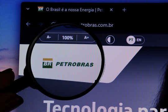 Salvador, Brazil - May 8, 2026: Petrobras logo on its official website seen through a magnifying glass. Brazilian oil industry. 