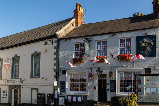 English Pub Facade with Flags and Flowers in Richmond, North Yorkshire, England