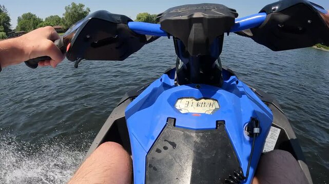Man casually boating on river with jet ski on sumer day - close up on speedometer