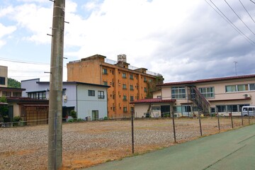 Naklejka premium May 4, 2026, Kaminoyama City, Yamagata Prefecture.A scene from an abandoned apartment building.