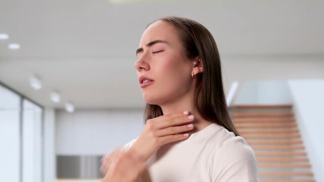 Woman Touching Swollen Gland In Throat Feeling Pain