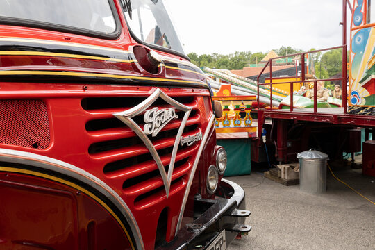 Dudley, west midlands united kingdom 15 November 2021 Close-Up of Red Vintage Fairground Truck Parked Next to Colorful Amusement Rides