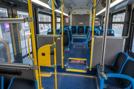  Interior of Modern City Bus with Empty Passenger Seating Yellow Handrails and Urban Public Transportation Design