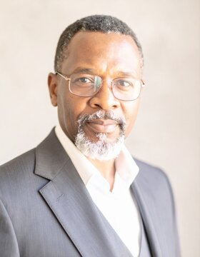 portrait of sophisticated mature african american businessman with glasses
