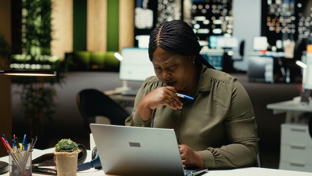 Focused businesswoman reflecting on a business strategy puzzle, envisioning creative concepts and projecting future outcomes. Deep contemplation to inspire a new perspective on the problem. Camera B.