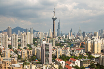 Naklejka premium Storm clouds over Nanjing skyline with modern towers and apartments