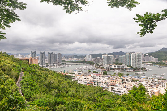 Elevated view of Sanya marina and coastal skyline with boats and high rise buildings, Hainan, China