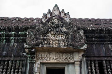 Naklejka premium Carved Stone Pediment with Mythological Scenes at Angkor Wat