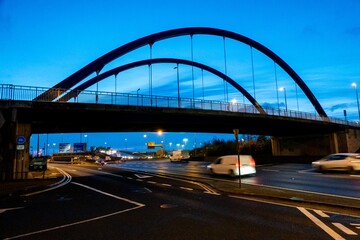 Naklejka premium Joe Williams Bridge in Dublin Ireland at Blue Hour with Traffic Light Trails and Urban Highway Cityscape