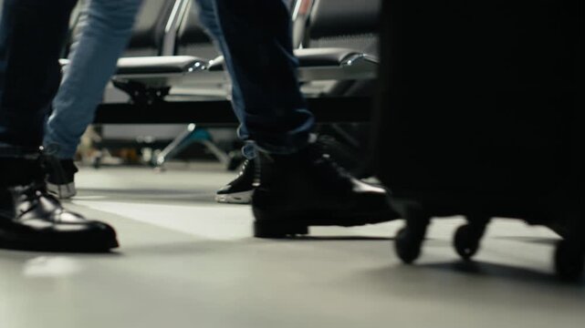 Carrying trolley, airport checkin and close up of tourist in lounge going to boarding gate. Traveler pushing wheeled luggage in aviation terminal, walking, doing journey back home, camera A