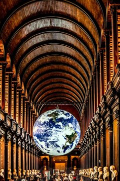  Gaia Earth Installation in Long Room Trinity College Library Dublin with Historic Bookshelves Barrel Vault Ceiling and Dramatic Interior