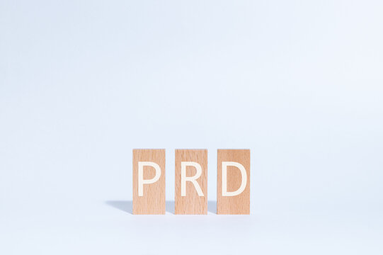 Eye-catching image of PRD text on wood blocks. The word stands for Product Requirements Document.