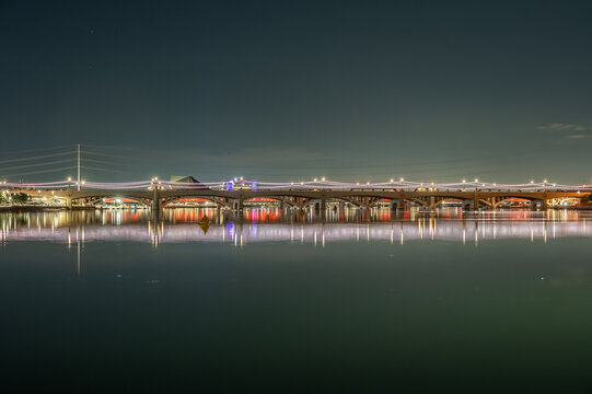  Tempe Town Lake Arizona Light Rail Bridge at Night with City Lights and Reflections Across Calm Water