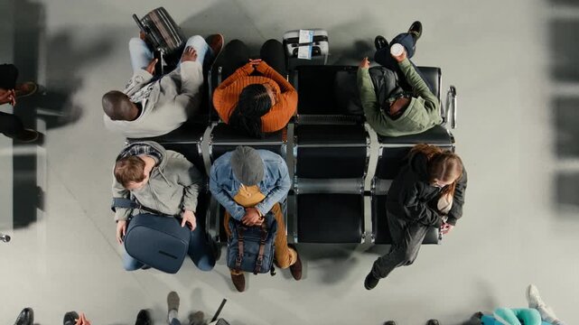 People waiting in airport lounge, checking flight schedule screen. Passengers carrying luggage in airplane departure terminal, looking at flight timetable on display, traveling on vacation