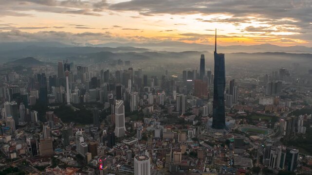 Aerial view time lapse 4k video of Kuala Lumpur city center view during dawn overlooking the city skyline in Federal Territory, Malaysia. Tilt up