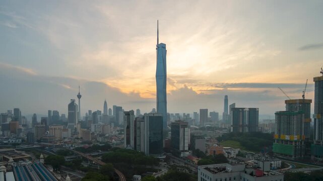 Aerial view time lapse 4k video of Kuala Lumpur city center view during dawn overlooking the city skyline in Federal Territory, Malaysia. Tilt up