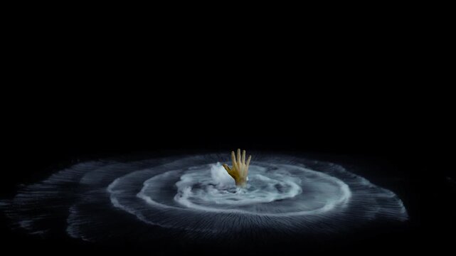 Human hand rising from bubbling mist