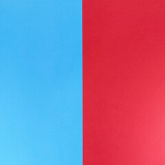 Fototapeta premium Blue and red split background showing a vertical two-tone textured paper surface ideal for minimal design, banners, posters, layouts and graphic projects requiring clean contrast and copy space.