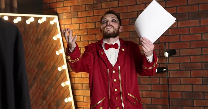 Actor with script rehearsing his lines in dressing room