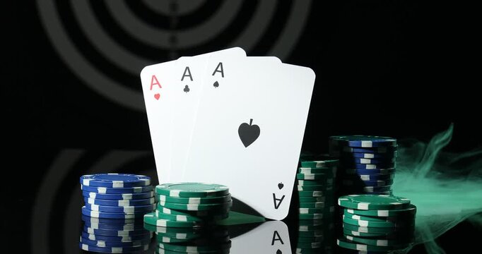 Playing cards and casino chips in smoke on black mirror table, closeup